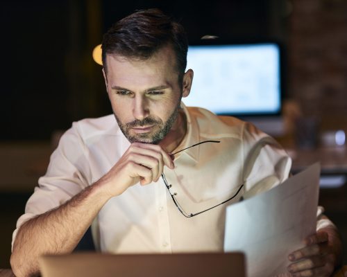 focused-man-working-late-his-home-office-scaled.jpg